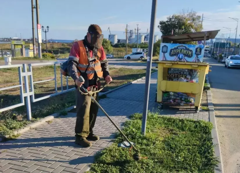 В Ейске коммунальщики с утра косят траву и убирают территории у контейнеров